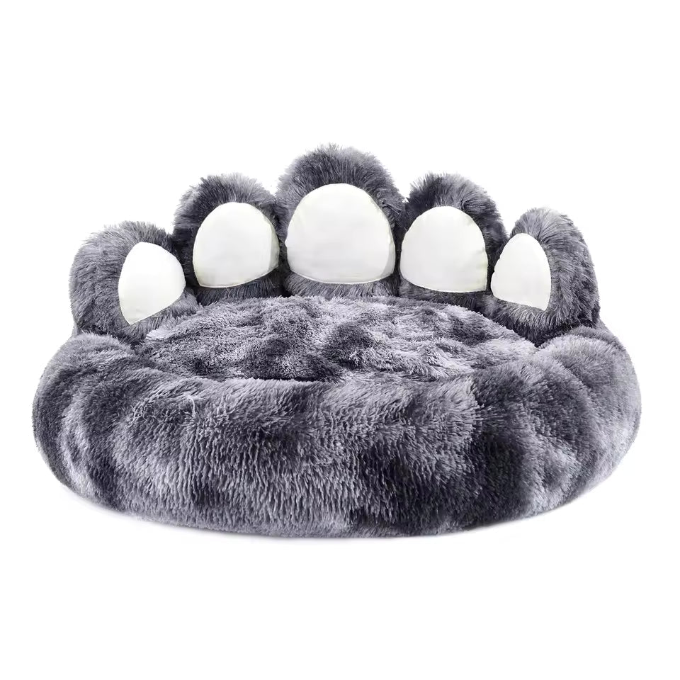 Gray paw-shaped pet bed with white pads on a white background